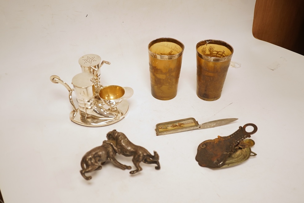 A novelty horse-related cruet stand, a pair of silver mounted horn beakers and three other items